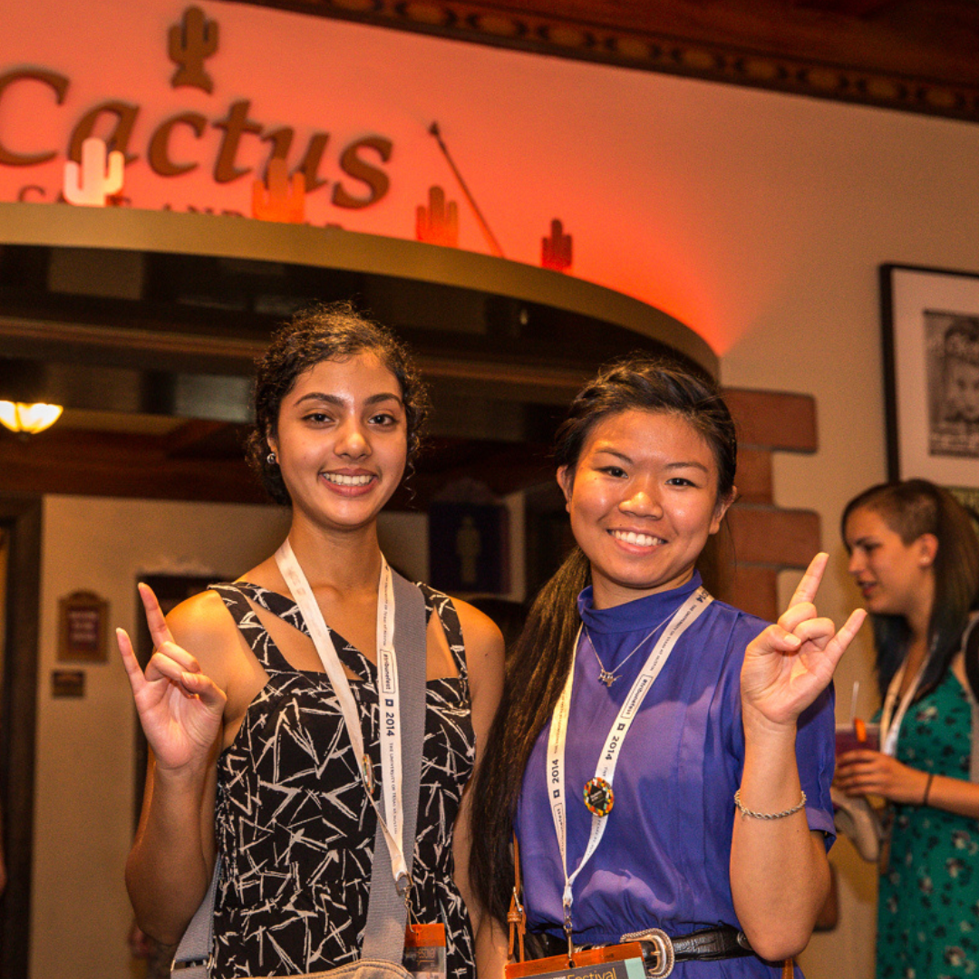 Two students holding up the hook 'em longhorn hand symbol