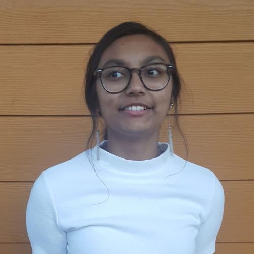Pic of Rishika looking towards the side, with a smile